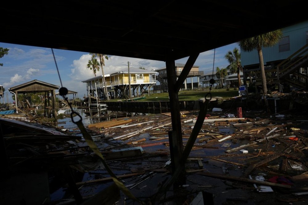FILE - Debris from destroyed homes and structures floats in a canal in Horseshoe Beach, Fla., Aug. 31, 2023, one day after the passage of Hurricane Idalia. (AP Photo/Rebecca Blackwell, File)