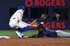 Tampa Bay Rays' left fielder Chandler Simpson, right, is tagged out at second base by Toronto Blue Jays shortstop Bo Bichette (11) on an attempted steal in second inning American League baseball action in Toronto on Wednesday, May 14, 2025. THE CANADIAN PRESS/Jon Blacker