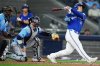 Toronto Blue Jays' Daulton Varsho (right) hits a three-run home run as Tampa Bay Rays catcher Danny Jansen (19) looks on during eighth inning MLB baseball action in Toronto on Tuesday, May 13, 2025. THE CANADIAN PRESS/Nathan Denette