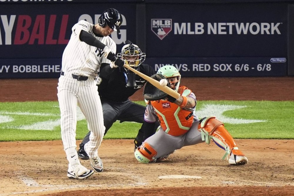 New York Yankees' Cody Bellinger hits a grand slam home run during the eighth inning of a baseball game against the New York Mets Sunday, May 18, 2025, in New York. (AP Photo/Frank Franklin II)