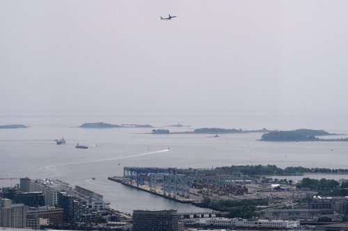Hazy skies diminish the view of the Boston Harbor Islands, Wednesday, June 4, 2025, in Boston, Mass. (AP Photo/Robert F. Bukaty)