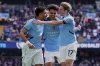 Manchester City's Nico O'Reilly, center, celebrates with teammates Omar Marmoush, left, and Kevin De Bruyne, after, scoring his side's fifth goal during the English Premier League soccer match between Manchester City and Crystal Palace at the Etihad stadium in Manchester, England, Saturday, April 12, 2025. (Martin Rickett/PA via AP)