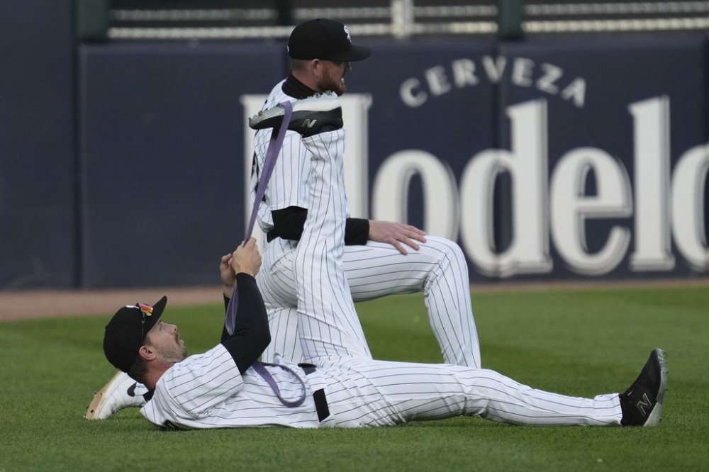 Chicago White Sox's Austin Slater, bottom, and Tim Elko warm up before a baseball game against the Seattle Mariners in Chicago, Monday, May 19, 2025. (AP Photo/Nam Y. Huh)