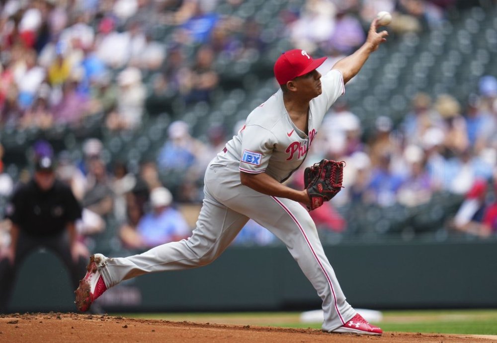 Philadelphia Phillies starting pitcher Ranger Suarez throws to the plate during the first inning of a baseball game against the Colorado Rockies, Thursday, May 22, 2025, in Denver. (AP Photo/Jack Dempsey)