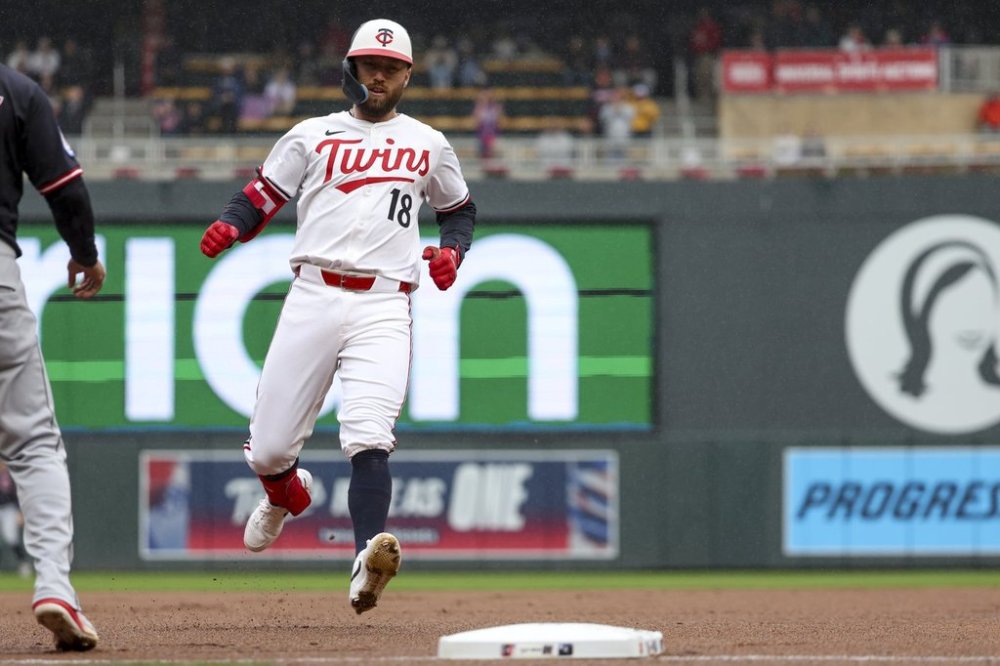 Minnesota Twins' Kody Clemens (18) arrives at third base after hitting a triple during the fourth inning of a baseball game against the Cleveland Guardians that was suspended Monday because of rain and resumed, Wednesday, May 21, 2025, in Minneapolis. (AP Photo/Ellen Schmidt)