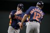 Houston Astros' Isaac Paredes, left, rounds the bases past third base coach Tony Perezchica (12) after hitting a three-run home run off Texas Rangers relief pitcher Robert Garcia during the eighth inning of a baseball game in Arlington, Texas, Sunday, May 18, 2025. (AP Photo/Jerome Miron)