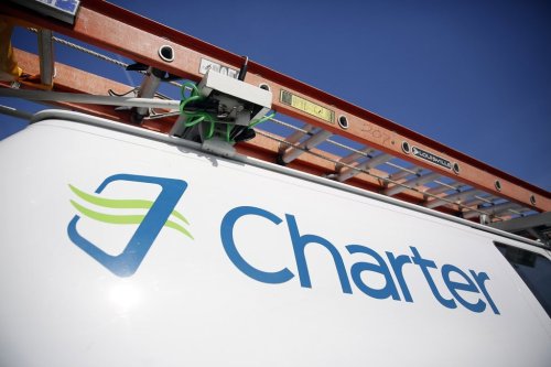 FILE - This April 1, 2015, file photo, shows a Charter Communications van in St. Louis. (AP Photo/Jeff Roberson, File)