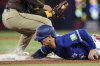 Toronto Blue Jays' Daulton Varsho (5) safely dives back into third base during first inning MLB baseball action against the San Diego Padres in Toronto on Thursday, May 22, 2025. THE CANADIAN PRESS/Chris Young
