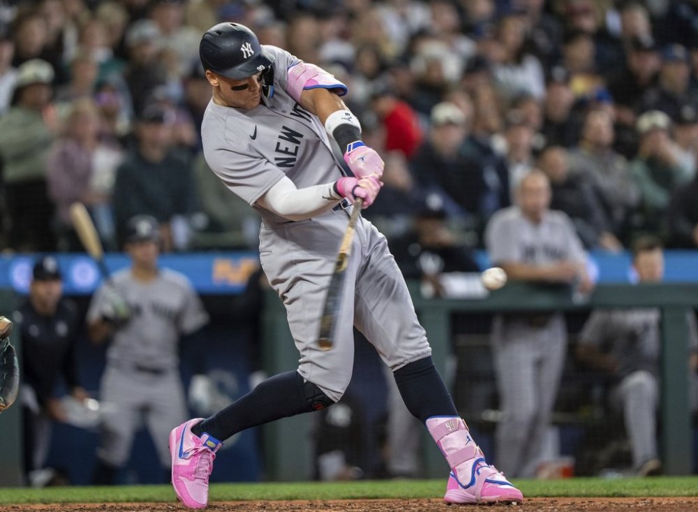 New York Yankees' Aaron Judge hits a solo home run during the eighth inning of a baseball game against the Seattle Mariners, Wednesday, May 14, 2025, in Seattle. (AP Photo/Stephen Brashear)