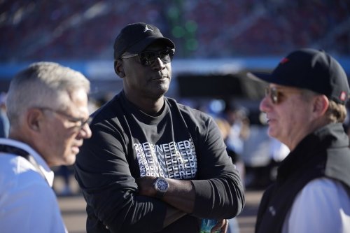 FILE - Michael Jordan, center, and Curtis Polk, left, co-owners of 23XI Racing, watch during qualifying beside 23XI Racing President Steve Lauletta, right, for a NASCAR Cup Series Championship auto race, Nov. 9, 2024, in Avondale, Ariz. (AP Photo/John Locher, file)