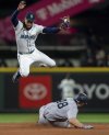 New York Yankees' Paul Goldschmidt steals second base below the tag of Seattle Mariners shortstop J.P. Crawford during the ninth inning of a baseball game, Tuesday, May 13, 2025, in Seattle. (AP Photo/Stephen Brashear)