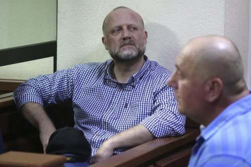 Opposition leader Zurab Japaridze, center, accused of failing to fulfill the demands of the Georgian parliament's temporary investigative commission probing the activities of the 2003-2012 government and its officials, attends a court hearing in Tbilisi, Georgia, Thursday, May 22, 2025. (Irakli Gedenidze/Pool Photo via AP)