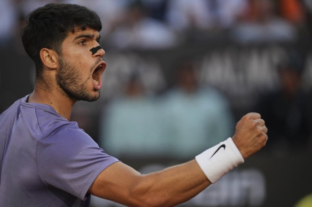 FILE - Spain's Carlos Alcaraz, wearing a nasal strip, reacts after scoring a point against Italy's Jannik Sinner in the final of the Italian Open tennis tournament at the Foro Italico in Rome, May 18, 2025. (AP Photo/Alessandra Tarantino, File)