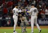 New York Yankees' Paul Goldschmidt, right, congratulates relief pitcher Devin Williams, left, and catcher Austin Wells after defeating the Los Angeles Angels, Tuesday, May 27, 2025, in Anaheim, Calif. (AP Photo/Kevork Djansezian)