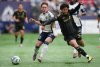 Vancouver Whitecaps' Tate Johnson, left, and Los Angeles FC's David Martinez vie for the ball during the first half of an MLS soccer match, in Vancouver, on Sunday, May 11, 2025. THE CANADIAN PRESS/Darryl Dyck