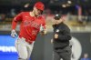 Los Angeles Angels' Mike Trout, left, rounds the bases after hitting a home run against the Minnesota Twins during the seventh inning of a baseball game, Friday, April 25, 2025, in Minneapolis. (AP Photo/Craig Lassig)