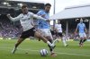 Fulham's Antonee Robinson, left, challenges for the ball with Manchester City's Omar Marmoush during the English Premier League soccer match between Fulham and Manchester City at Craven Cottage, London, Sunday, May 25, 2025. (AP Photo/Dave Shopland)