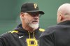 Pittsburgh Pirates manager Derek Shelton, left, talks with umpire Mike Estabrook between innings of a baseball game against the San Diego Padres in Pittsburgh, Saturday, May 3, 2025. (AP Photo/Gene J. Puskar)