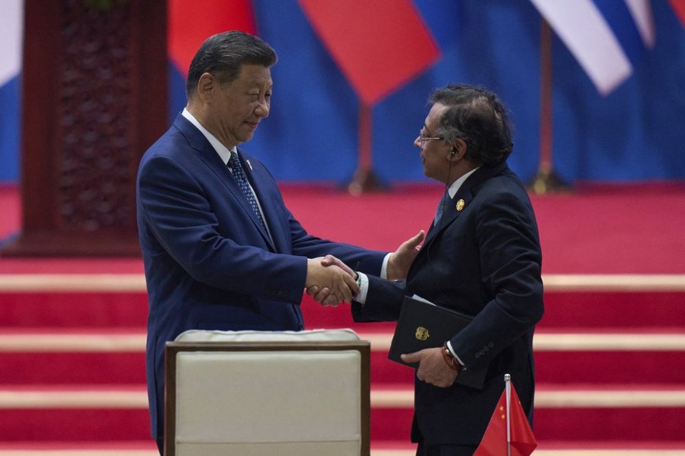 Chinese President Xi Jinping, left, shakes hands with Colombia's President Gustavo Petro after delivering his opening speech for the opening ceremony of the Fourth Ministerial Meeting of the Forum of China and Community of Latin American and Caribbean States at China National Convention Center in Beijing, Tuesday, May 13, 2025. (AP Photo/Andy Wong)