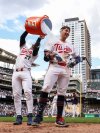 Minnesota Twins' Brooks Lee is doused with water by Ryan Jeffers after his walk off single against the Kansas City Royals during the ninth inning of baseball game Saturday, May 24, 2025, in Minneapolis. (AP Photo/Matt Krohn)