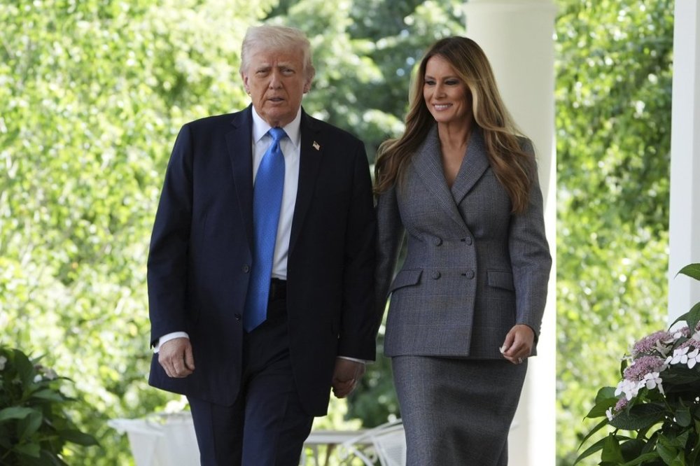 President Donald Trump, left, and first lady Melania Trump arrive to speak during a bill signing event for the