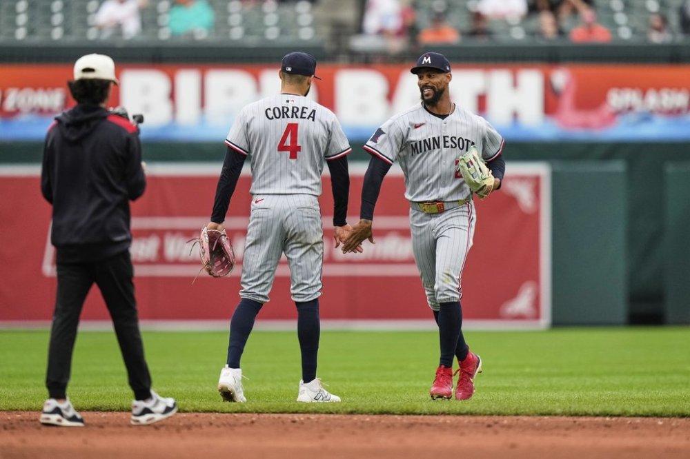 Minnesota Twins' Carlos Correa (4) and Byron Buxton, right, celebrate their team's victory over the Baltimore Orioles after the first baseball game of a doubleheader, Wednesday, May 14, 2025, in Baltimore. (AP Photo/Stephanie Scarbrough)