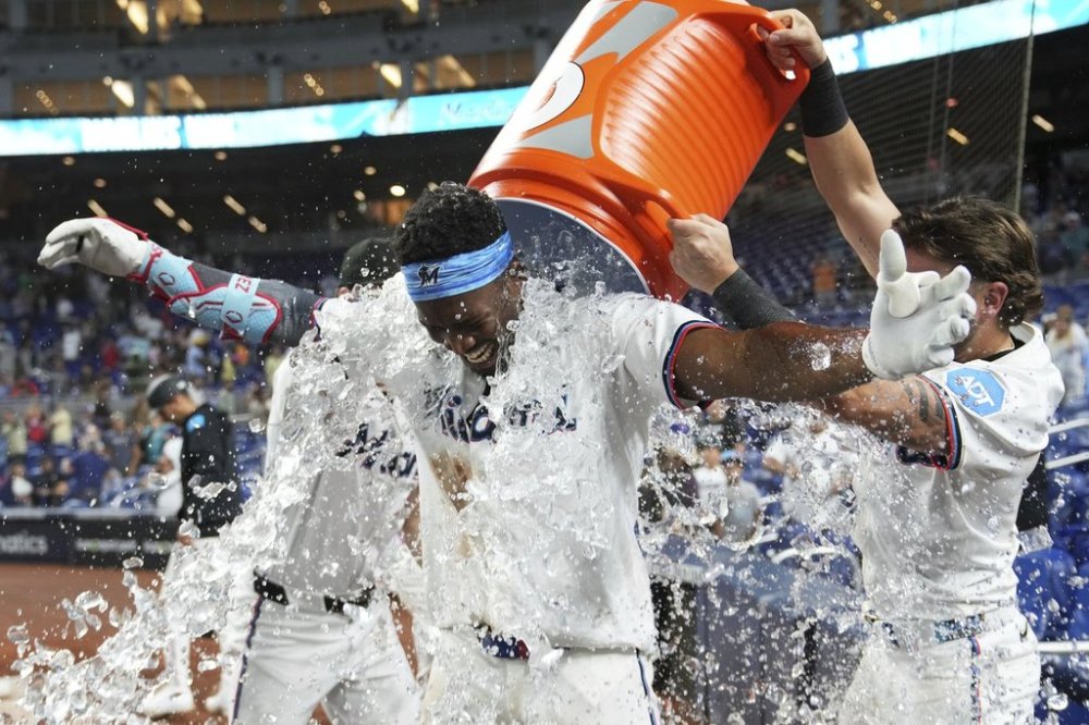 Miami Marlins' Jesus Sanchez is doused with ice after hitting a walk-off triple to defeat the Chicago Cubs in a baseball game Monday, May 19, 2025, in Miami. (AP Photo/Lynne Sladky)