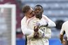 PSG's Ousmane Dembele, right, and PSG's goalkeeper Arnau Tenas talk during a training session ahead of the Champions League final soccer match between Paris Saint-Germain and Inter Milan in Munich, Germany, Friday, May 30, 2025. (AP Photo/Luca Bruno)