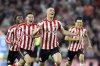 Sunderland's Daniel Ballard, center, and teammates celebrate after the final whistle against Coventry in a Sky Bet Championship play-off semifinal, second leg soccer match at the Stadium of Light, Tuesday May 13, 2025, in Sunderland, England. (Steve Welsh/PA via AP)