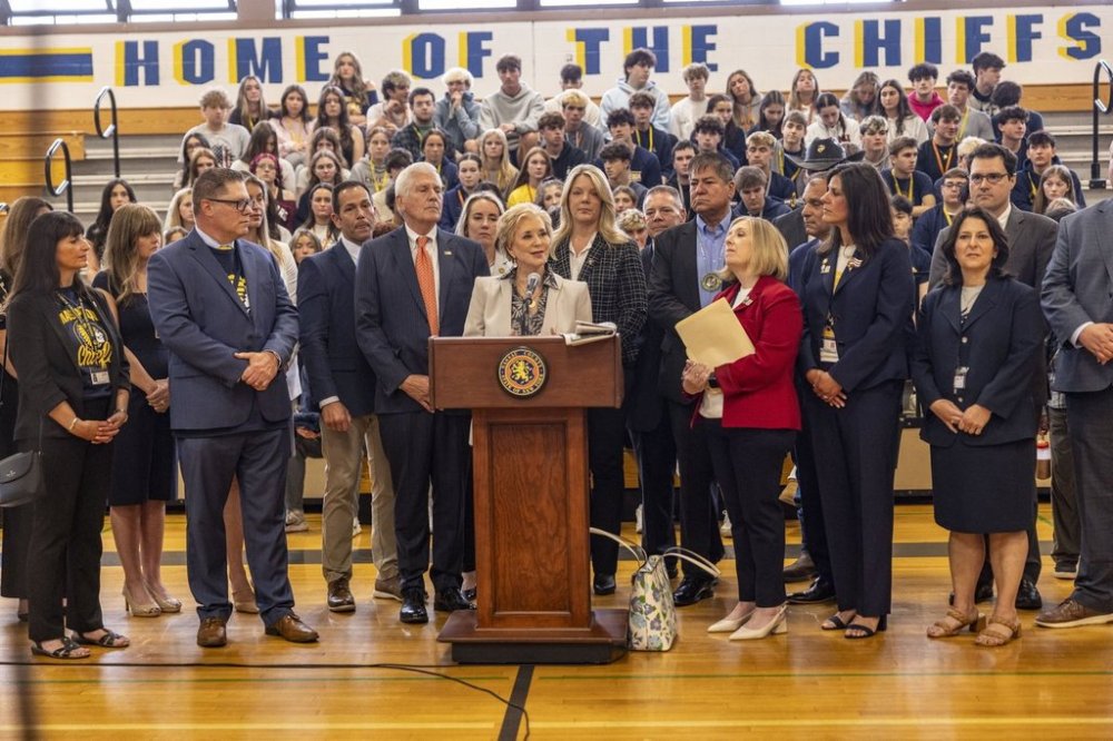 U.S. Secretary of Education Linda McMahon, center, joined by local elected officials speaks during a visit to Massapequa High School, Friday, May 30, 2025, in Massapequa, N.Y. (Alejandra Villa Loarca/Newsday via AP)