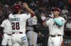 Arizona Diamondbacks' Josh Naylor, right, celebrates with Eugenio Suárez (28) after hitting a two-run home run against the Pittsburgh Pirates in the fifth inning during a baseball game, Monday, May 26, 2025, in Phoenix. (AP Photo/Rick Scuteri)