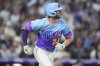 Colorado Rockies' Ryan McMahon follows the flight of his double that drove in two runs off New York Yankees relief pitcher Tim Hill in the fifth inning of a baseball game Friday, May 23, 2025, in Denver. (AP Photo/David Zalubowski)