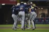 Members of the Seattle Mariners celebrate after the team defeated the San Diego Padres 4-1 in a baseball game Saturday, May 17, 2025, in San Diego. (AP Photo/Gregory Bull)