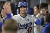 Los Angeles Dodgers' Shohei Ohtani is congratulated in the dugout after hitting a solo home run in the seventh inning of a baseball game against the New York Mets, Monday, June 2, 2025, in Los Angeles. (AP Photo/Jayne Kamin-Oncea)