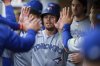 Toronto Blue Jays' Addison Barger, center, is greeted in the dugout after scoring on an RBI single hit by Ernie Clement during the third inning of a baseball game against the Seattle Mariners, Friday, May 9, 2025, in Seattle. (AP Photo/Rio Giancarlo)