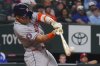 Houston Astros' Cam Smith hits a single that scored teammates Jake Meyers during the seventh inning of a baseball game against the Texas Rangers, Friday, May 16, 2025, in Arlington, Texas. (AP Photo/LM Otero)