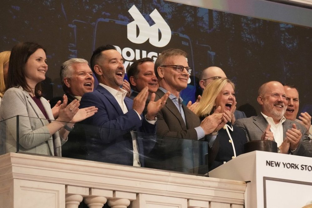 Douglas Dynamics Executive Vice President & Chief Financial Officer Sarah Lauber, second from right, rings the New York Stock Exchange opening bell, Monday, May 12, 2025. (AP Photo/Richard Drew)