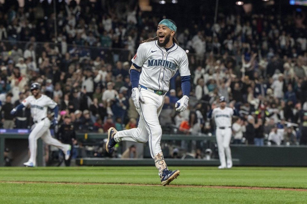 Seattle Mariners' J.P. Crawford celebrates after hitting and RBI-single during the eleventh inning of a baseball game against the New York Yankees, Tuesday, May 13, 2025, in Seattle. (AP Photo/Stephen Brashear)