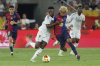 Barcelona's Lamine Yamal, right, fights for the ball with Real Madrid's Vinicius Junior during the Spanish Copa del Rey final soccer match between Barcelona and Real Madrid at Estadio de La Cartuja stadium in Seville, Spain, Saturday, April 26, 2025. (AP Photo/Joan Monfort)