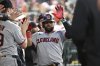 Cleveland Guardians designated hitter Carlos Santana, center, celebrates in the dugout after scoring against the Detroit Tigers in the 10th inning of a baseball game Saturday, May 24, 2025, in Detroit. (AP Photo/Lon Horwedel)