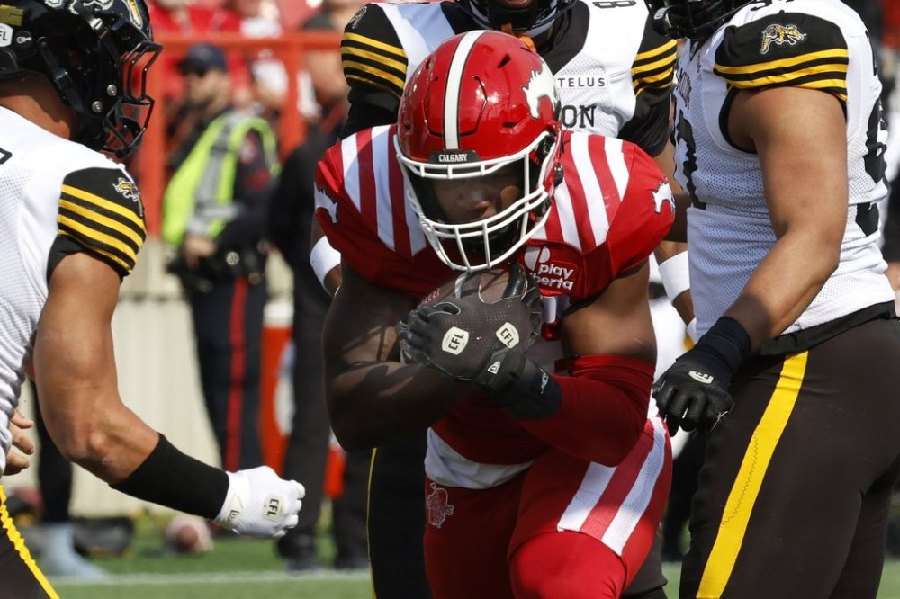 Calgary Stampeders' Dedrick Mills runs into the end zone for a touchdown during first half CFL football action against the Hamilton Tiger-Cats in Calgary, on Saturday, June 7, 2025. THE CANADIAN PRESS/Larry MacDougal