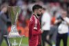 Manchester United's Bruno Fernandes walks past the trophy at the end of the Europa League final soccer match between Tottenham Hotspur and Manchester United at the San Mames Stadium in Bilbao, Spain, Wednesday, May 21, 2025. (AP Photo/Bernat Armangue)