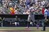 New York Yankees' Aaron Judge, left, points skyward after hitting a solo home run during the fourth inning of a baseball game against the Athletics, Saturday, May 10, 2025, in West Sacramento, Calif. (AP Photo/Sara Nevis)