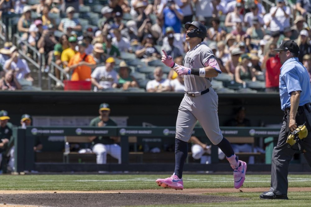 New York Yankees' Aaron Judge, left, points skyward after hitting a solo home run during the fourth inning of a baseball game against the Athletics, Saturday, May 10, 2025, in West Sacramento, Calif. (AP Photo/Sara Nevis)