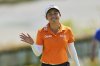 Jeeno Thitikul, of Thailand, waves as she arrives on the 18th green during the final round of the Mizuho Americas Open LPGA golf tournament, Sunday, May 11, 2025, in Jersey City, N.J. (AP Photo/Seth Wenig)