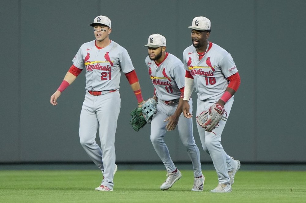 St. Louis Cardinals outfielders Lars Nootbaar (21), Victor Scott II (11) and Jordan Walker (18) celebrate after their baseball game against the Kansas City Royals, Saturday, May 17, 2025, in Kansas City, Mo. (AP Photo/Charlie Riedel)