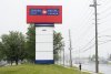 People walk past the Canada Post facility in Mississauga, Ont., on Thursday, May 22, 2025. Canada Post is set to meet with the postal workers' union on Sunday, May 25, 2025. THE CANADIAN PRESS/Nathan Denette