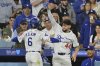 Los Angeles Dodgers' Hyeseong Kim (6) and Andy Pages (44) celebrate Kim's solo home run as manager Dave Roberts, bottom right, looks on in the fifth inning of a baseball game against the Oakland Athletics, Wednesday, May 14, 2025, in Los Angeles. (AP Photo/Jayne Kamin-Oncea)