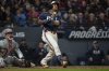 Cleveland Guardians' Jose Ramirez, right, watches his solo home run off Philadelphia Phillies relief pitcher Joe Ross as Phillies catcher Rafael Marchan, left, looks on during the seventh inning of a baseball game Friday, May 9, 2025, in Cleveland. (AP Photo/Phil Long)