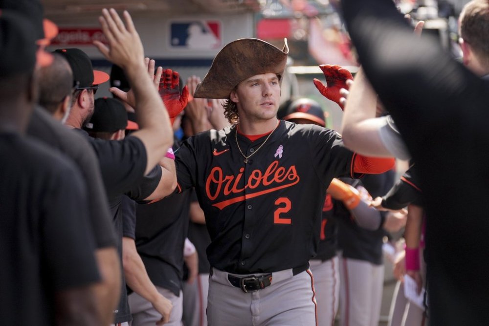 Baltimore Orioles' Gunnar Henderson (2) high-fives teammates in the dugout after hitting a home run during the sixth inning of a baseball game against the Los Angeles Angels, Sunday, May 11, 2025, in Anaheim, Calif. (AP Photo/Eric Thayer)